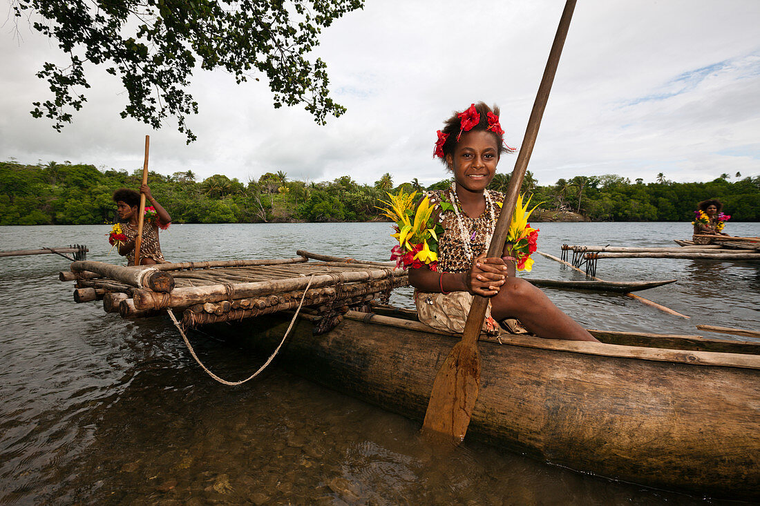 Girl rows outrigger boat, Tufi, Oro province, Papua New Guinea