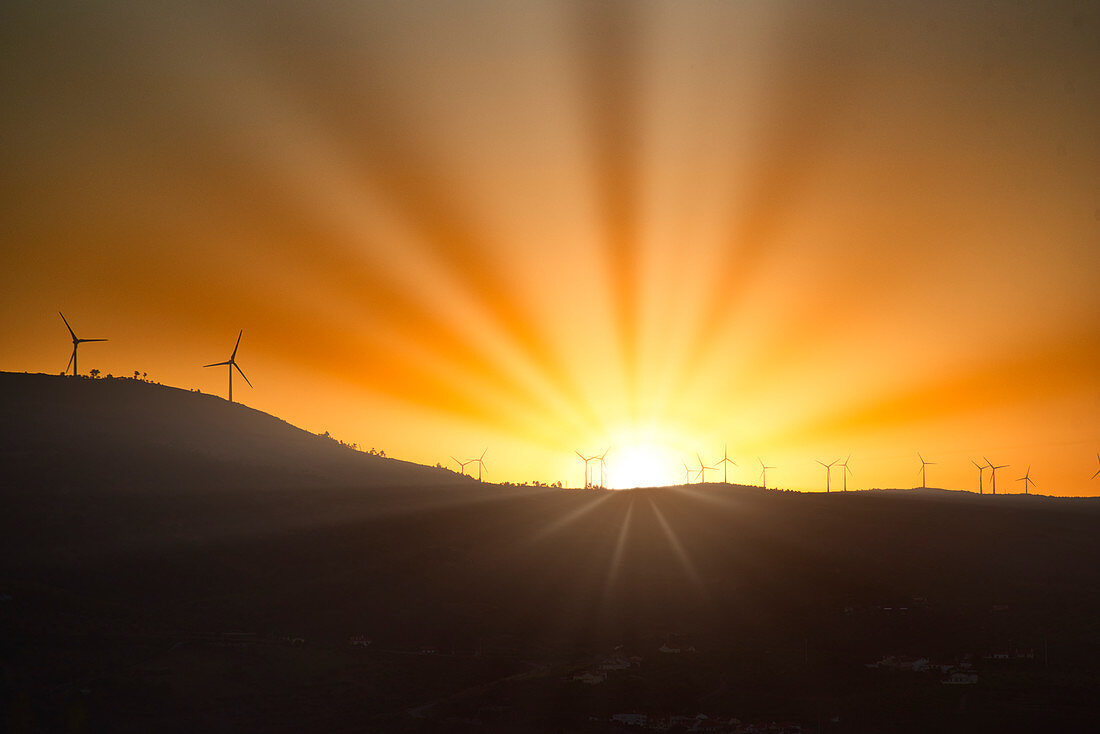 Sunset over a mountain range with wind turbines at the Douro, northern Portugal, Portugal