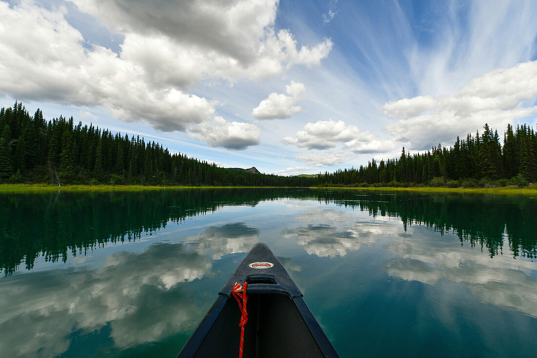 Blick aus einem Kanu auf den spiegelglatten Yukon River, Kanutour vom Lake Laberge nach Carmacks, Yukon, Kanada