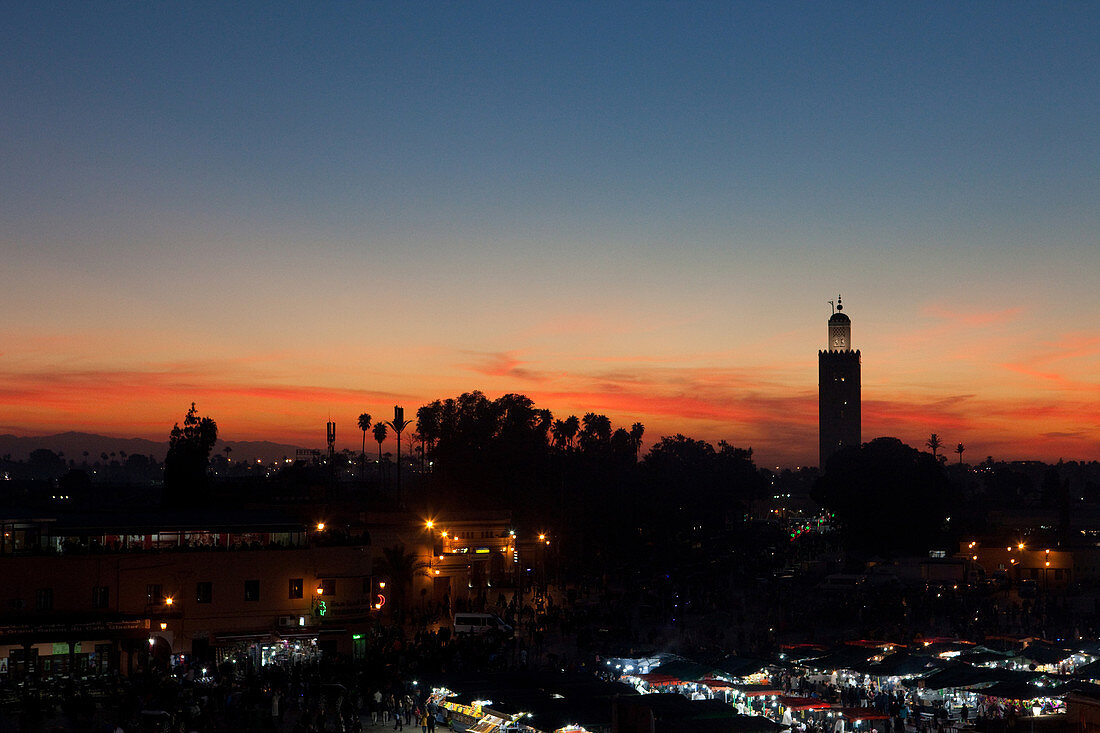 View from a rooftop bar at night over the main square Djemaa el-Fna and the city, Marrakech, Morocco