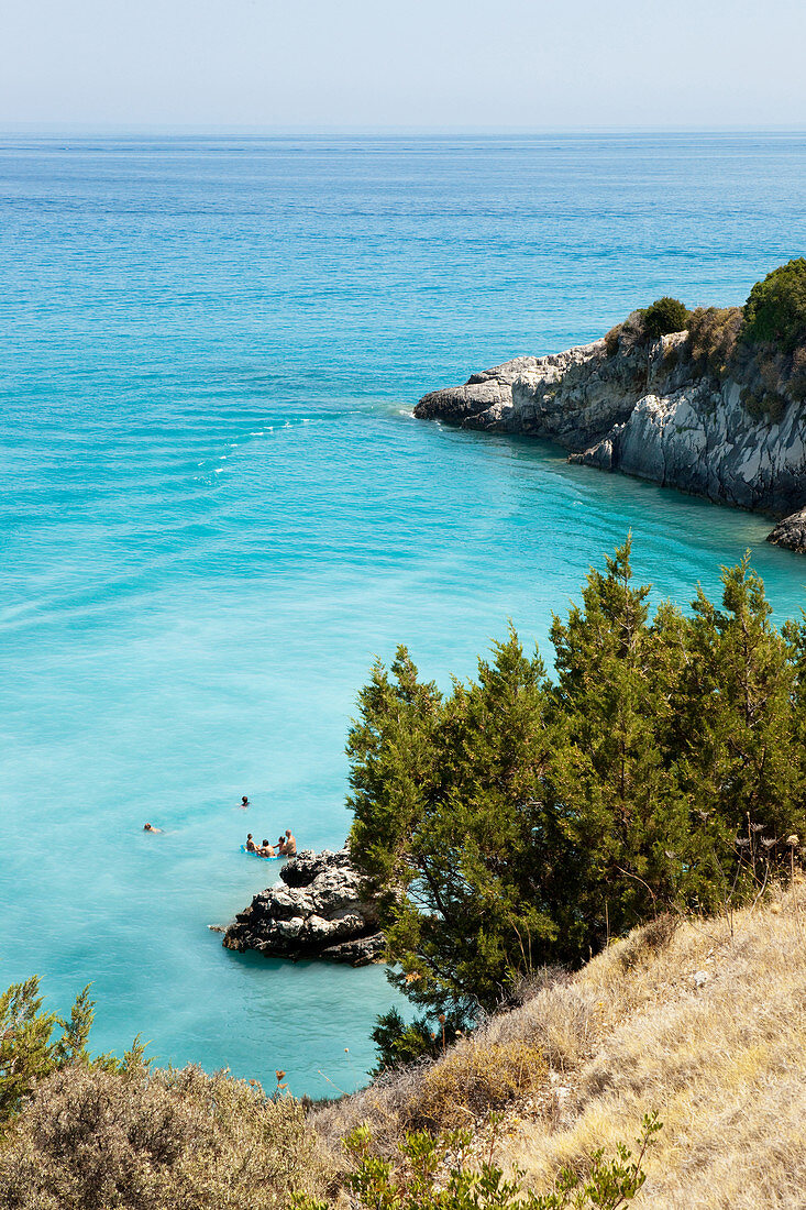 Bathers on Xigia sulfur beach with hot sulfur springs on the beach, Xigia bay, Zakynthos, Ionian islands, Greece