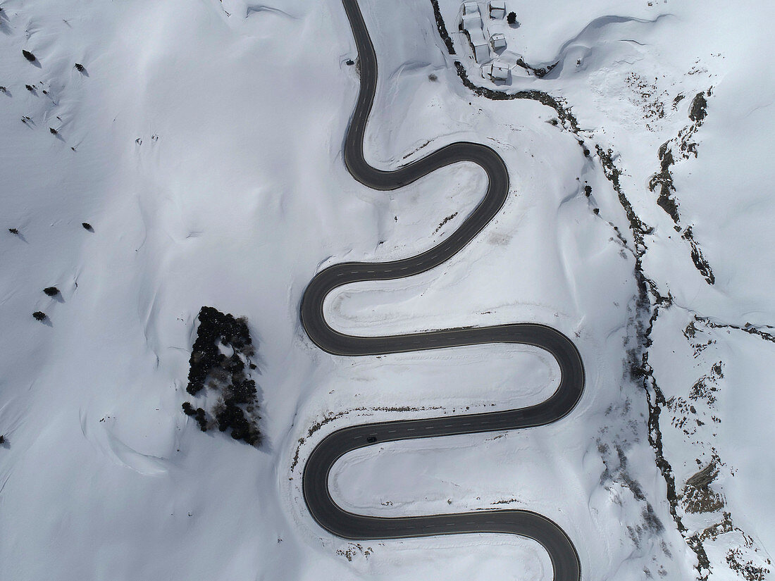 View from above winding Julier Pass through snow covered mountain, St. Moritz, Switzerland