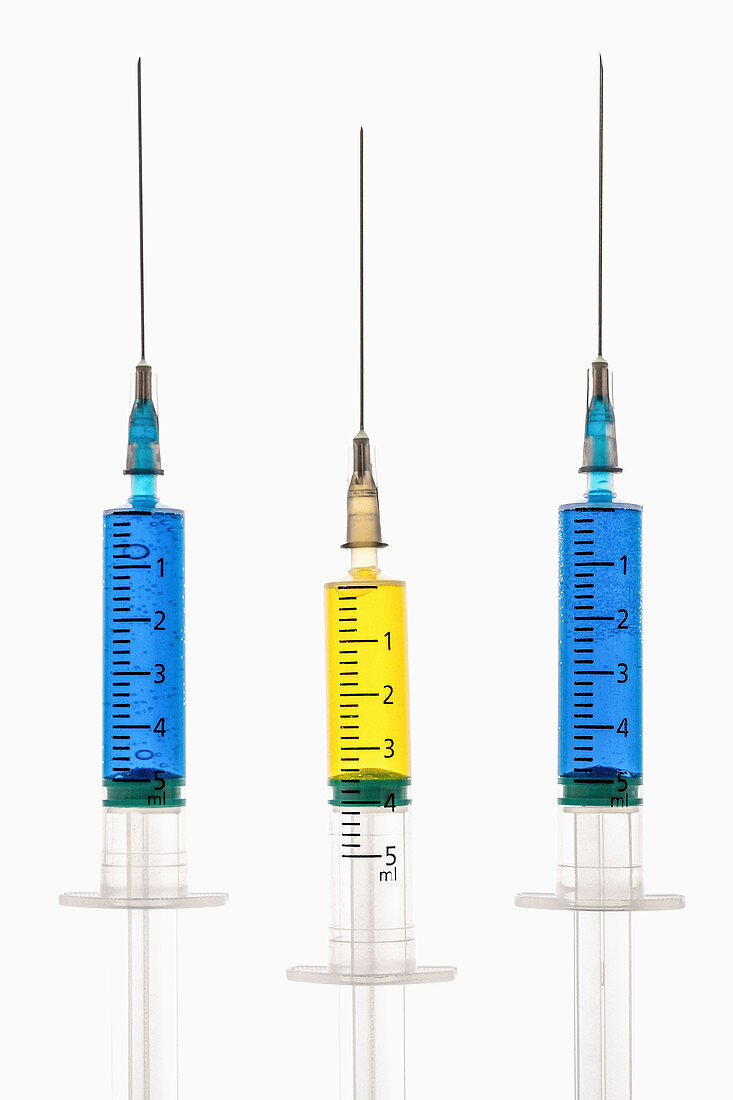Syringes with blue and yellow liquid