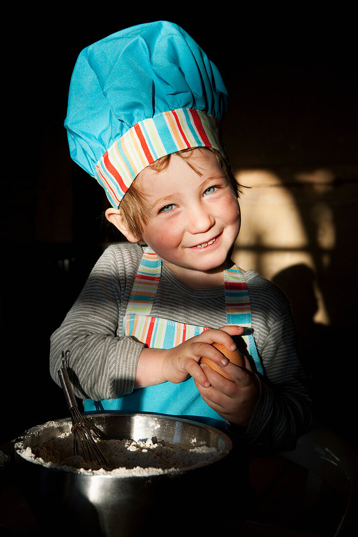 Portrait cute girl in chefs hat baking