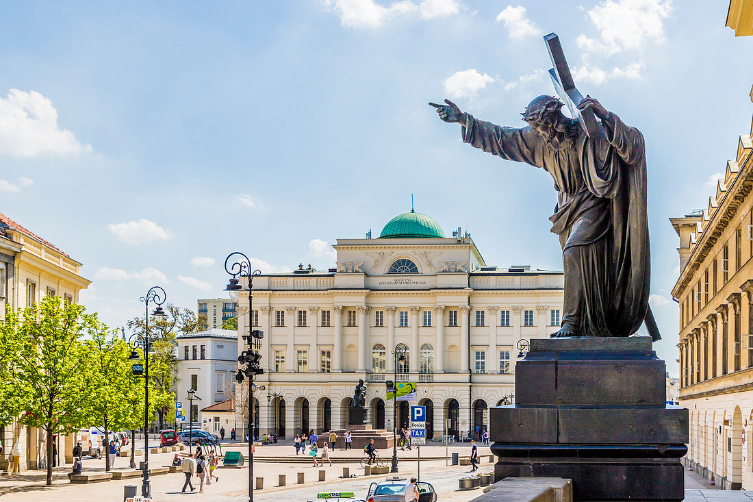 A statue and the Polish Academy of Sciences in the background, Old Town, UNESCO World Heritage Site, Warsaw, Poland, Europe