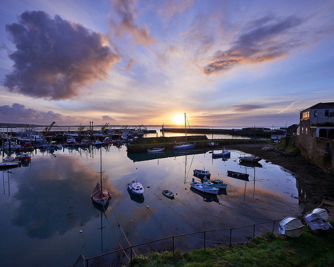Spring sunrise across the harbour at the fishing port of Newlyn, Cornwall, England, United Kingdom, Europe