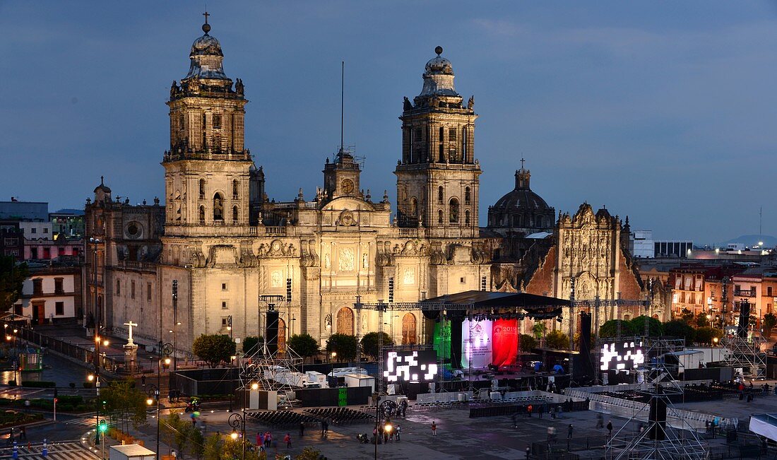 Evening view of the lit Cathedral at the Zocalo with stage and Mexican Flag, Mexico City, Mexico