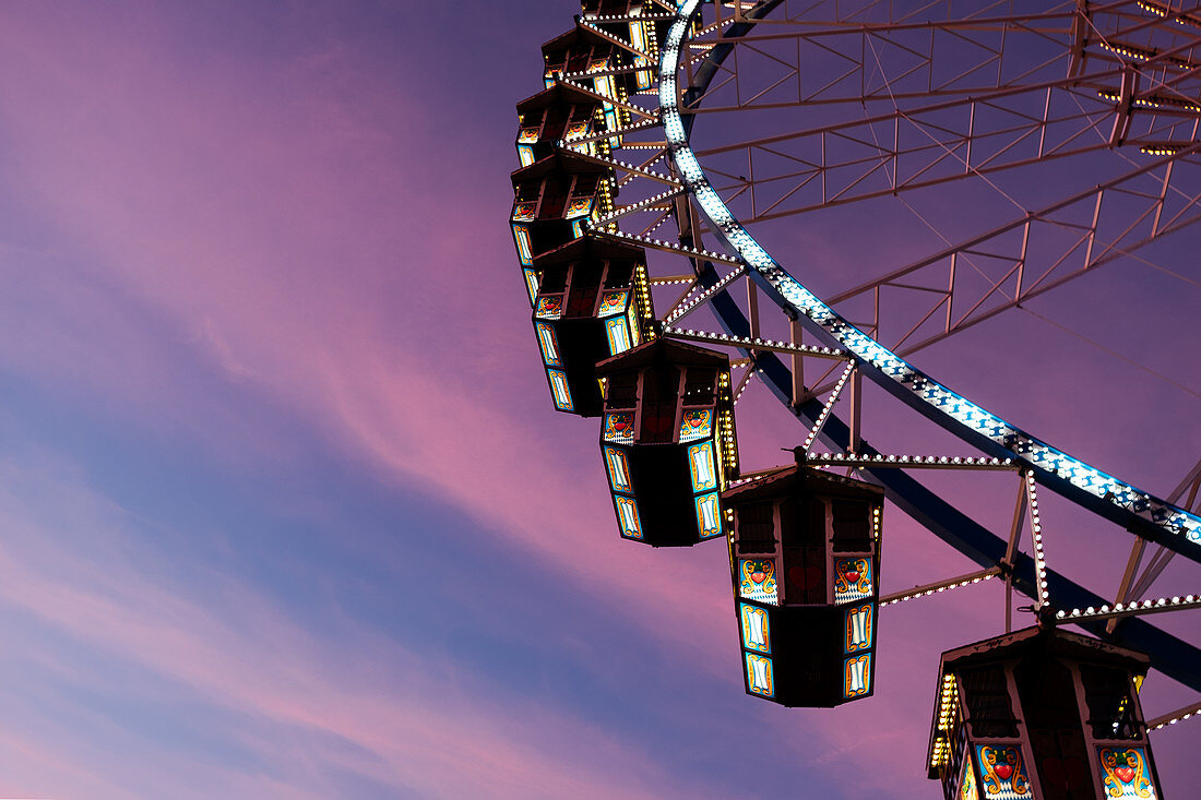 Ferris wheel at Oktoberfest at sunset; Munich; Germany