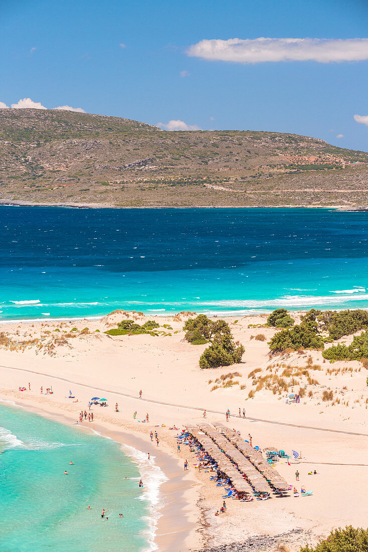 People on the narrow stretch of white sand which divides Simos beach, Elafonissos, Laconia Region, Peloponnese, Greece