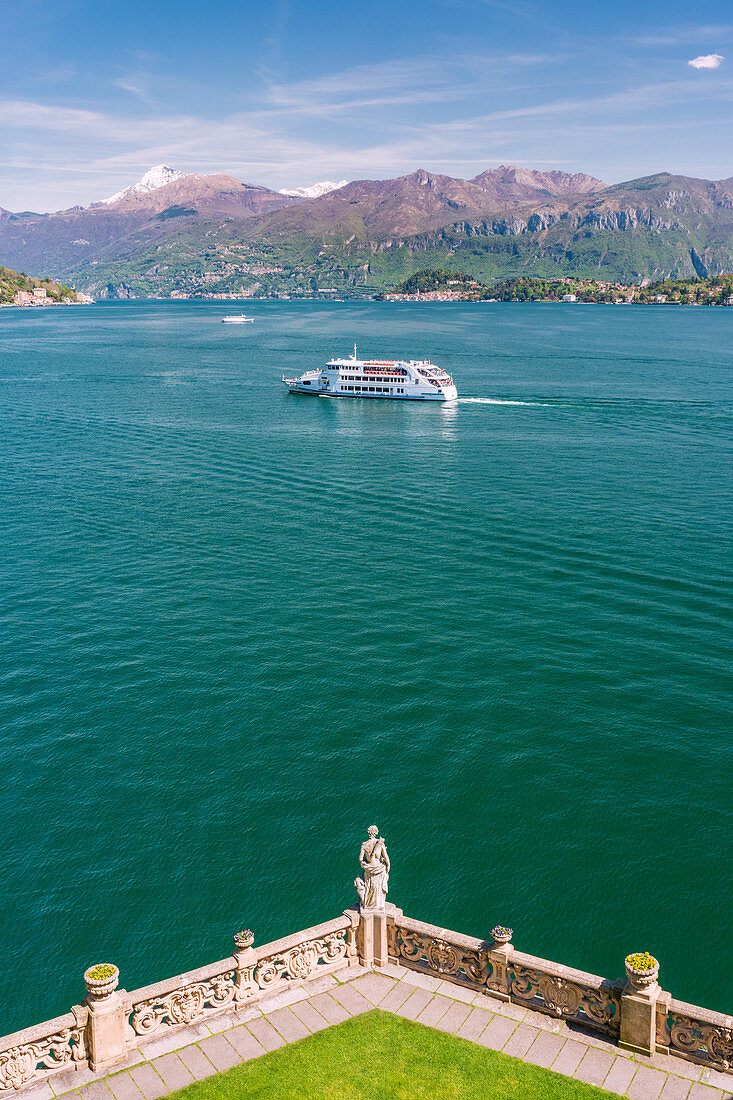 Touristic ferry on Lake Como viewed from Villa del Balbianello gardens on Punta di Lavedo, Lenno, Como province, Lombardy, italy