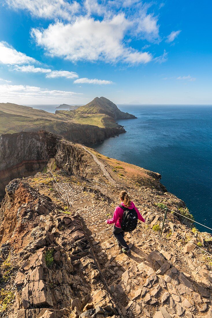 Woman walking on the trail to Point of Saint Lawrence. Canical, Machico district, Madeira region, Portugal.