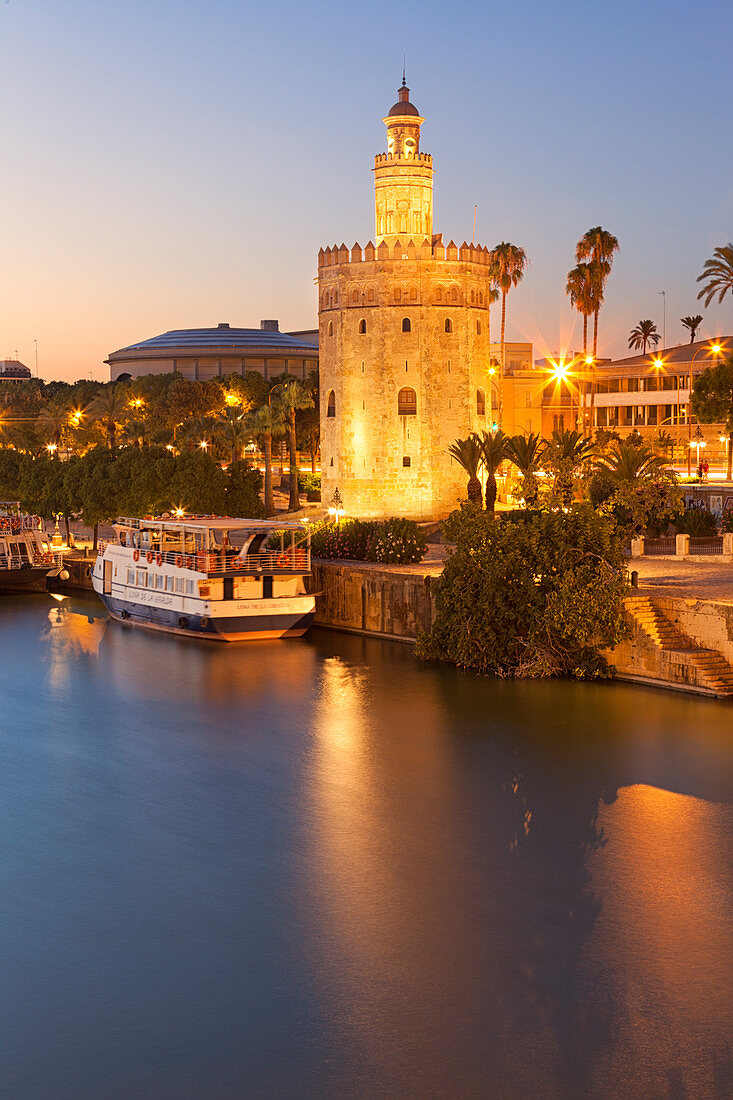 Torre del Oro (Tower of Gold) and river Guadalquivir at dusk from San Telmo bridge, Seville, province of Seville, Andalusia, Spain