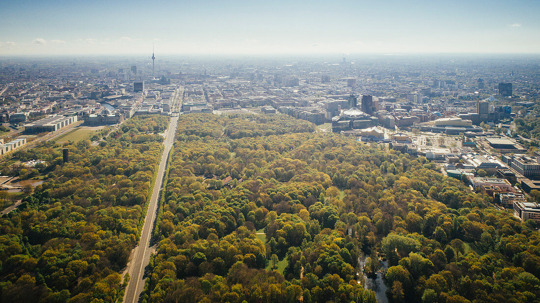 Drone point of view sunny Tiergarten Park and Berlin cityscape, Germany