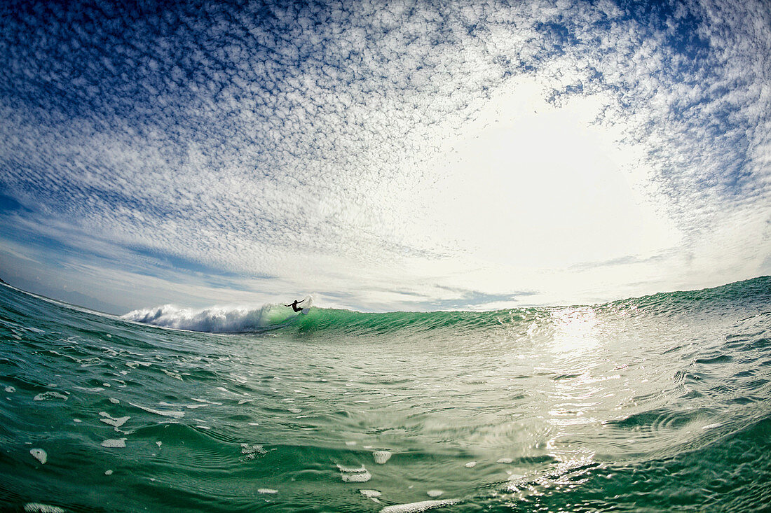 Surfer riding wave on sunny ocean, Punta Mita, Nayarit, Mexico