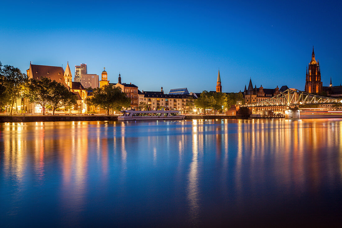 Buildings by river at sunset in Frankfurt, Germany