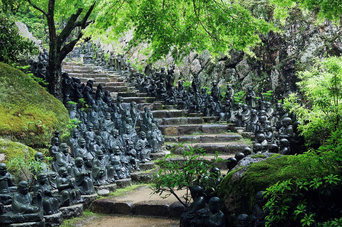 Statues lining steps in temple garden, Honshu island, Japan, Asia