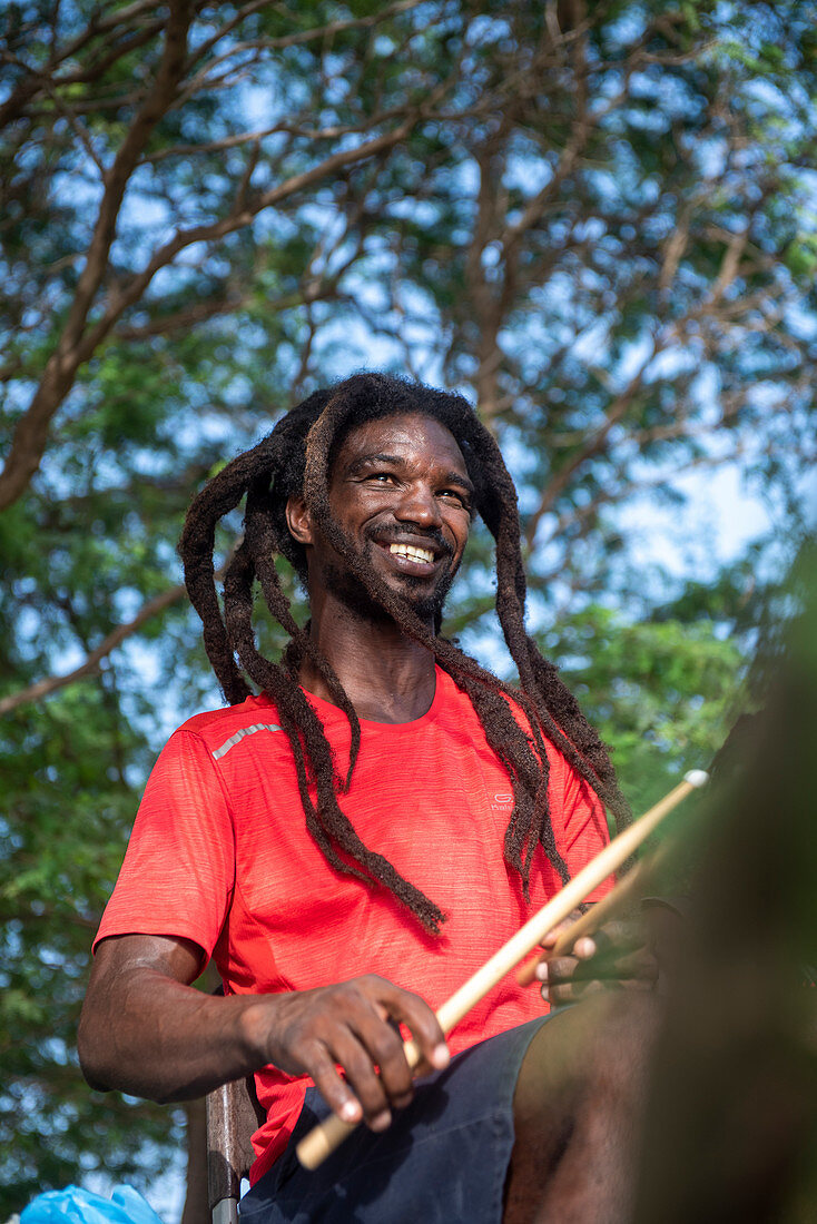 Cape Verde, Island Santiago, rasta man playing drums, music, smile