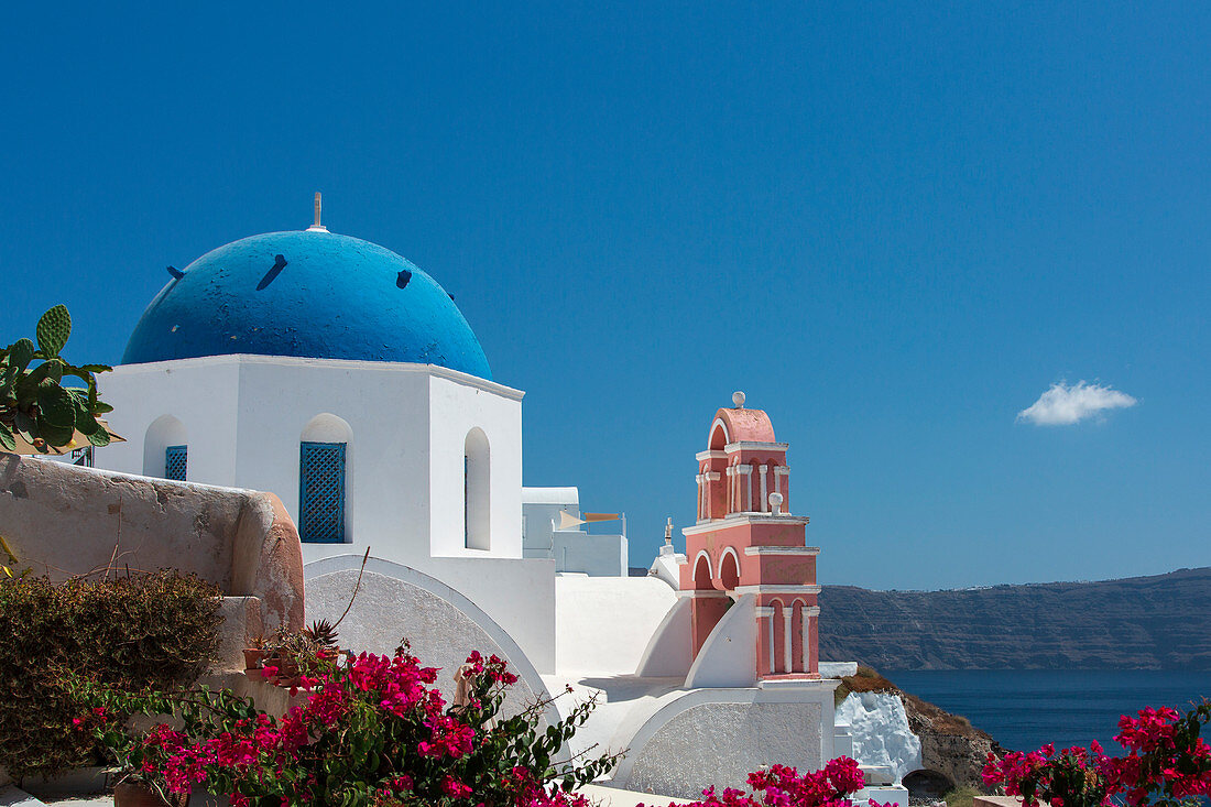 The pink chapel next to the blue dome in Oia, Santorini, Greece