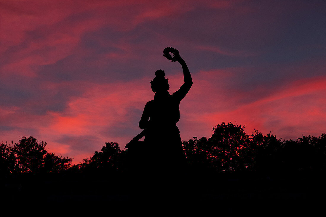 Silhouette of the Bavaria at sunset, Munich, Bavaria, Germany