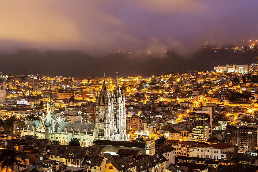 View from El Ventanal to the nocturnal illuminated Basílica del Voto Nacional in Quito.