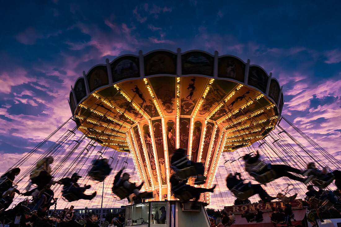 Traditional carousel on the Oiden Oktoberfest at sunset. Oktoberfest, Munich, Bavaria, Germany