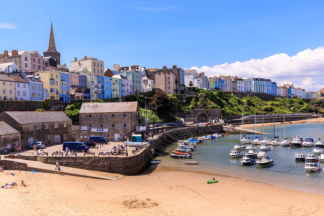Colourful historic town and St. Mary's church, from Harbour Beach, boats on a sunny day, Tenby, Pembrokeshire, Wales, United Kingdom, Europe