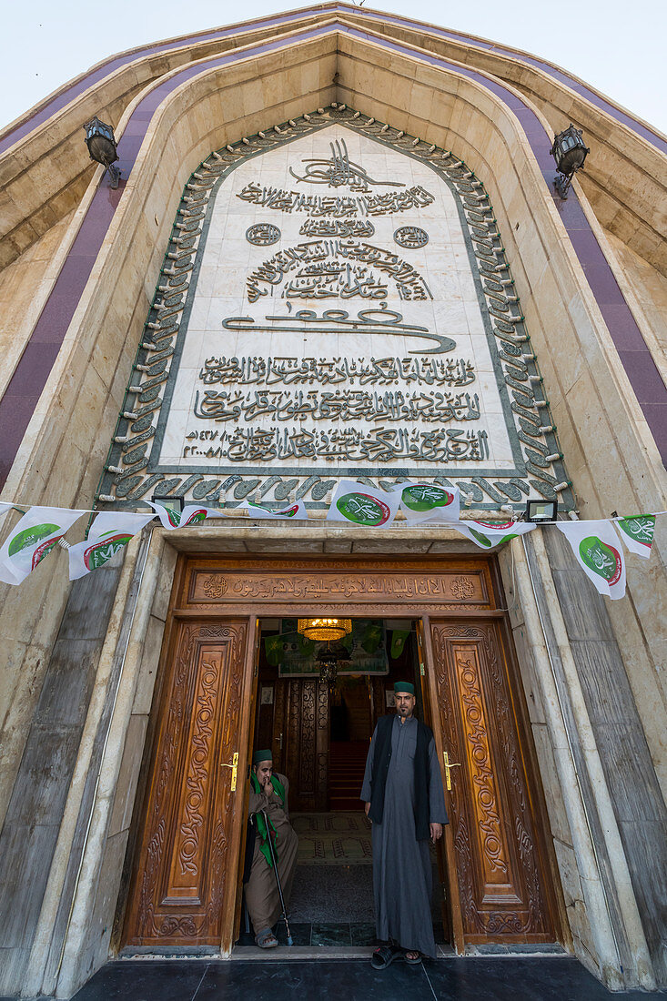 Sufi men standing in the Maruf al-Karkhi Sufi Mosque, Baghdad, Iraq, Middle East