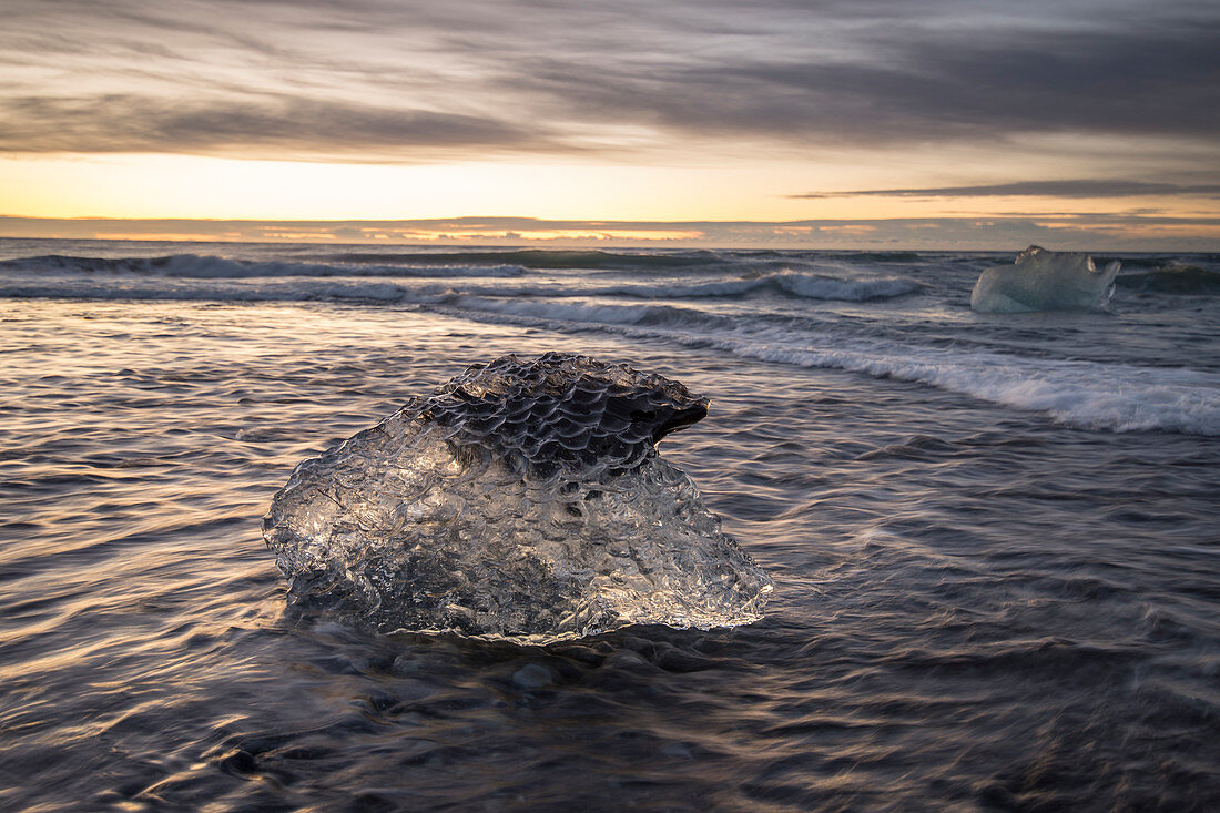 Piece of ice lying on†lakeshore of†Jokulsarlon at dusk, Iceland