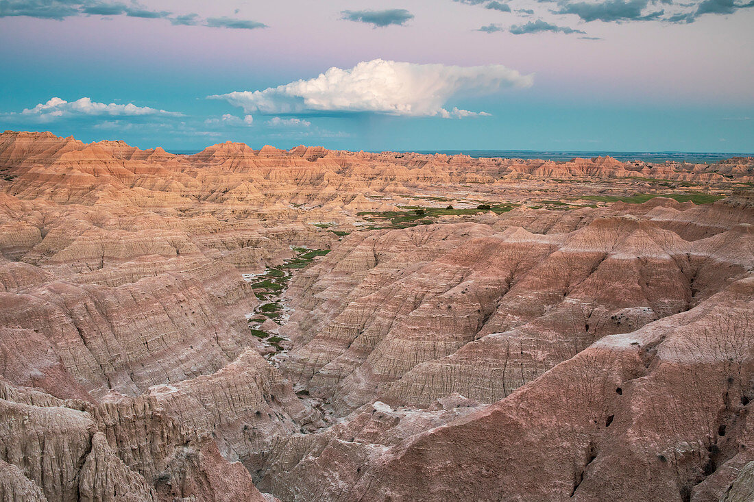 Clouds over rock formations of Badlands National Park at dusk, South Dakota, USA