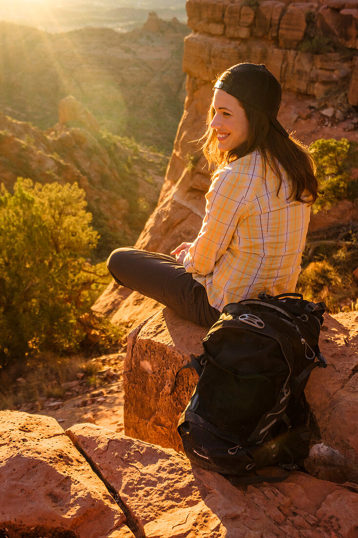 Portrait of female hiker smiling while enjoying sunset at Cathedral Rock, Arizona, USA