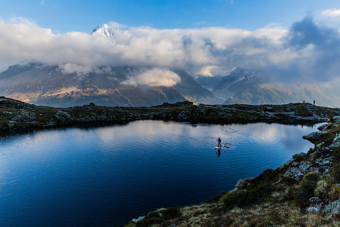 Person paddling on lac des Cheserys under lac Blanc in Chamonix, Haute Savoie, France