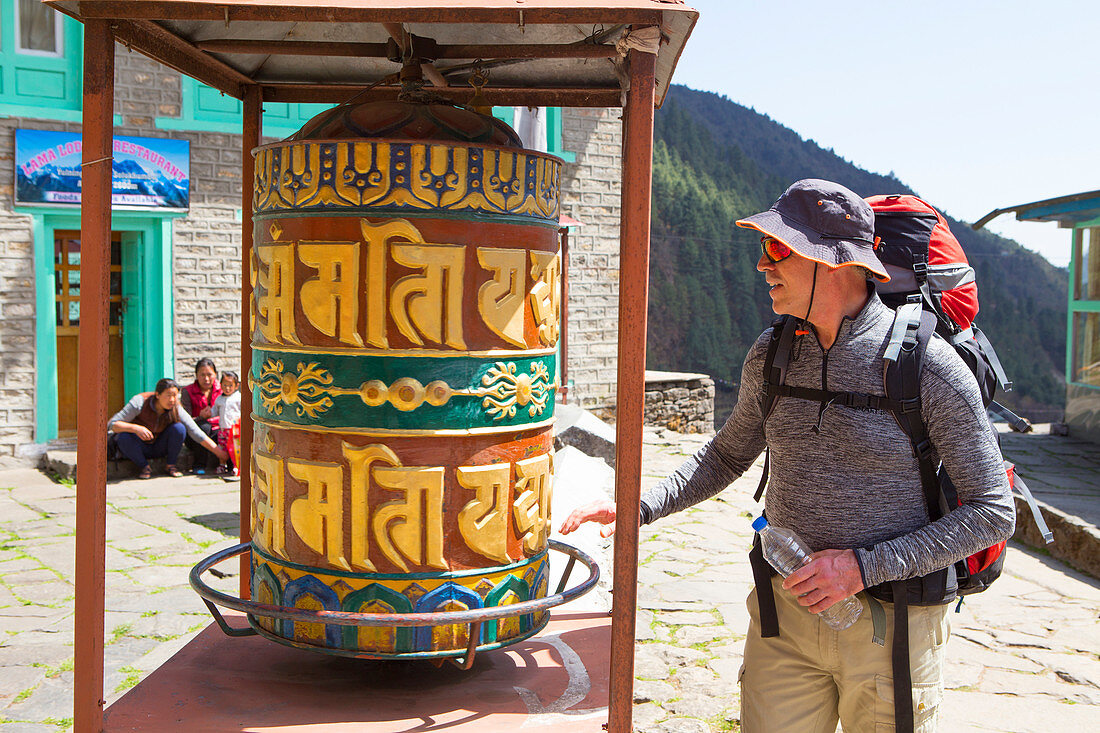 A hiker is turning a Buddhist prayer wheel along the way to Everest Base Camp. The trek to Everest Base Camp (EBC) is possibly the most dramatic and picturesque in the Nepalese Himalaya. Not only will you stand face to face with Mount Everest, Sagarmatha in Nepali language, at 8,848 m (29,029 ft), but you will be following in the footsteps of great mountaineers like Edmund Hillary and Tenzing Norgay. The trek is scenic and offers ever-changing Himalayan scenery through forests, hills and quaint villages. A great sense of anticipation builds as you trek up the Khumbu Valley, passing through int