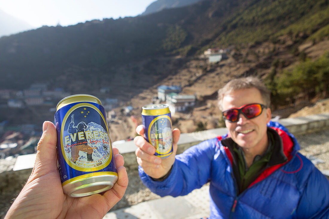 Two hikers drinking a Everest beer on a roof top in Namche Bazar after a long hiking day on the Everest Base Camp trek. The trek to Everest Base Camp (EBC) is possibly the most dramatic and picturesque in the Nepalese Himalaya. Not only will you stand face to face with Mount Everest, Sagarmatha in Nepali language, at 8,848 m (29,029 ft), but you will be following in the footsteps of great mountaineers like Edmund Hillary and Tenzing Norgay. The trek is scenic and offers ever-changing Himalayan scenery through forests, hills and quaint villages. A great sense of anticipation builds as you trek 