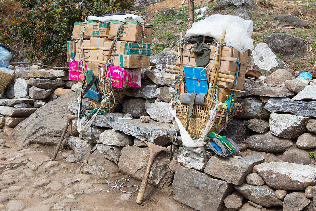 Two improvised backpacks of Nepalese porters, seen halfway the hike to Everest Base Camp in the Khumbu valley. The trek to Everest Base Camp (EBC) is possibly the most dramatic and picturesque in the Nepalese Himalaya. Not only will you stand face to face with Mount Everest, Sagarmatha in Nepali language, at 8,848 m (29,029 ft), but you will be following in the footsteps of great mountaineers like Edmund Hillary and Tenzing Norgay. The trek is scenic and offers ever-changing Himalayan scenery through forests, hills and quaint villages. A great sense of anticipation builds as you trek up the Kh