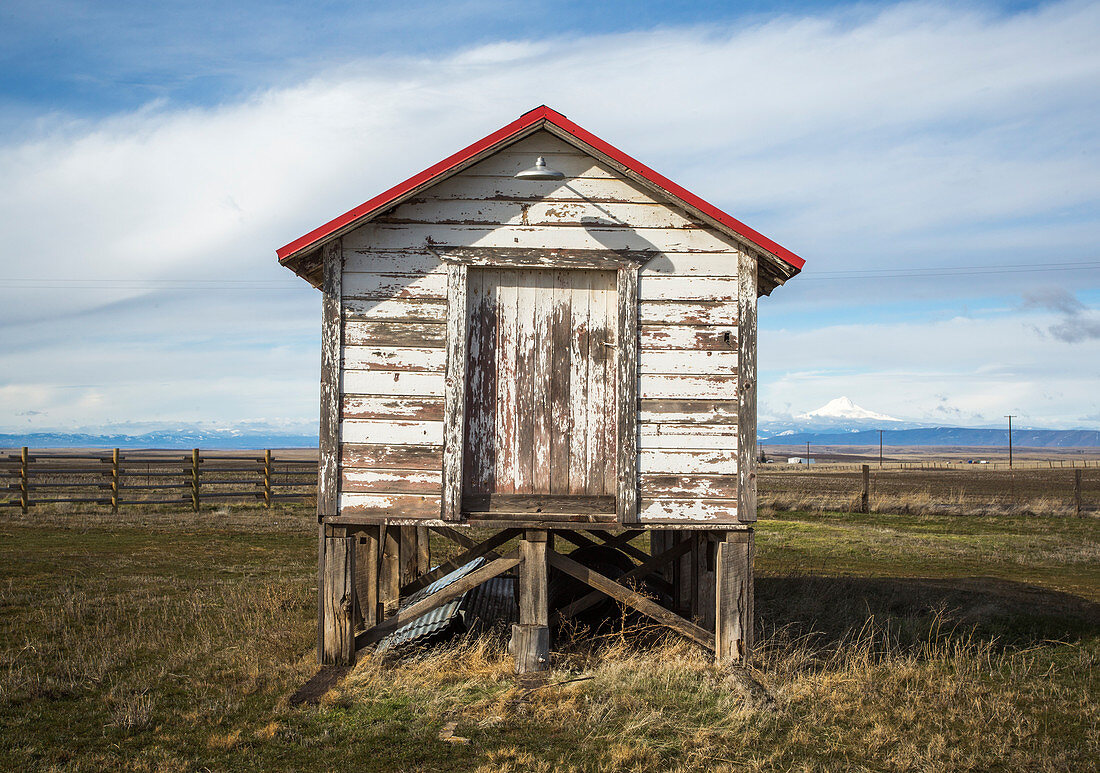 Old weathered stilt shed against clouds, Grass Valley, Oregon, USA