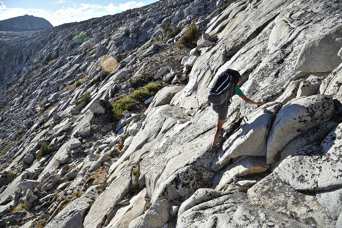 Backpackers hike across Humphreys Basin to Puppet Pass on a two-week trek of the Sierra High Route in the John Muir Wilderness in California. The 200-mile route roughly parallels the popular John Muir Trail through the Sierra Nevada Range of California from Kings Canyon National Park to Yosemite National Park. 