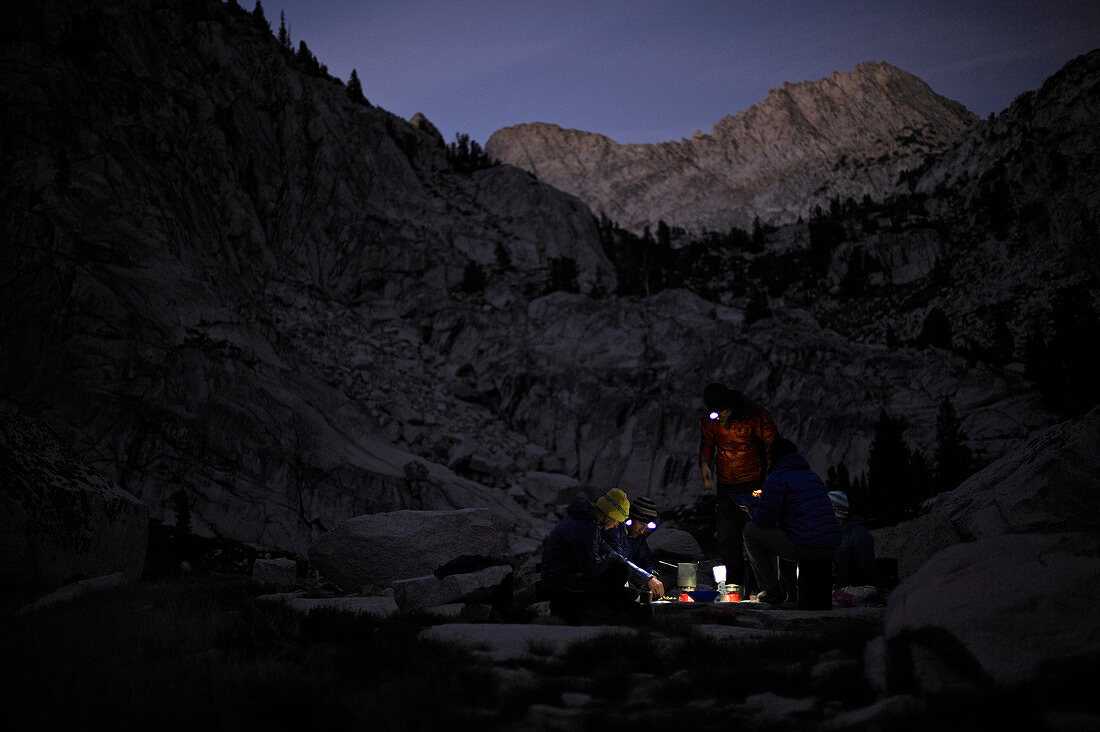 Backpackers prepare dinner by headlamp at Laurel Lake on a two-week trek of the Sierra High Route in the John Muir Wilderness in California. The 200-mile route roughly parallels the popular John Muir Trail through the Sierra Nevada Range of California from Kings Canyon National Park to Yosemite National Park. 