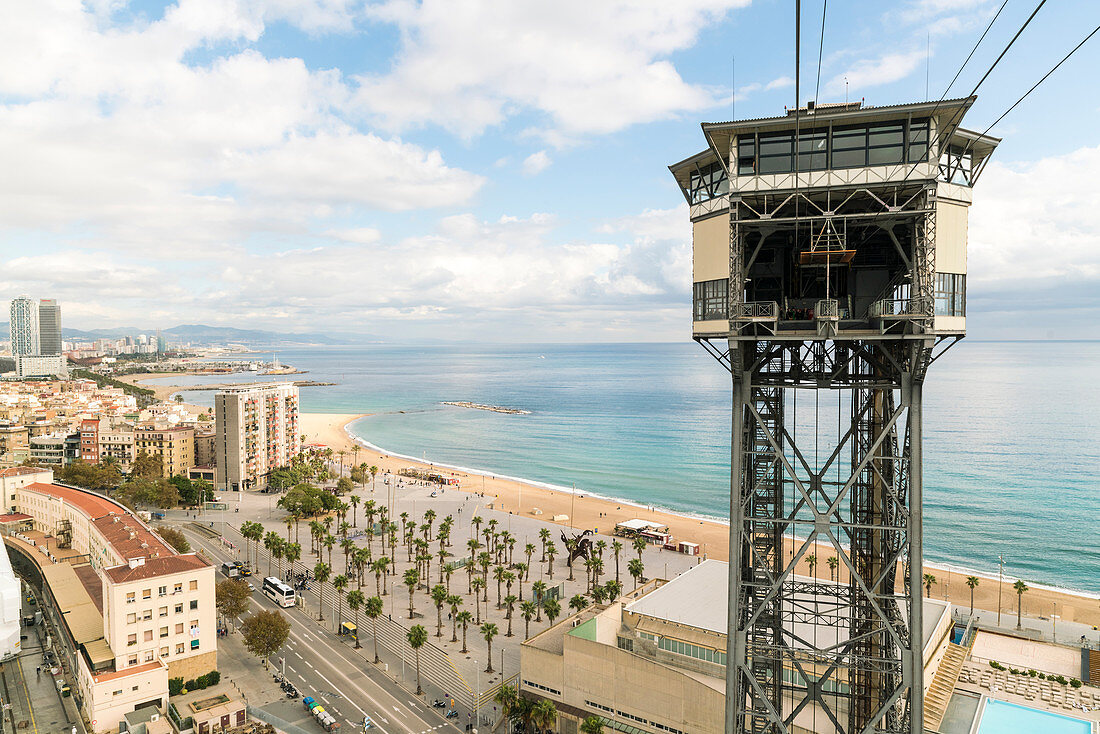 Tower at Barcelona harbor with beach and city in background, Catalonia, Spain
