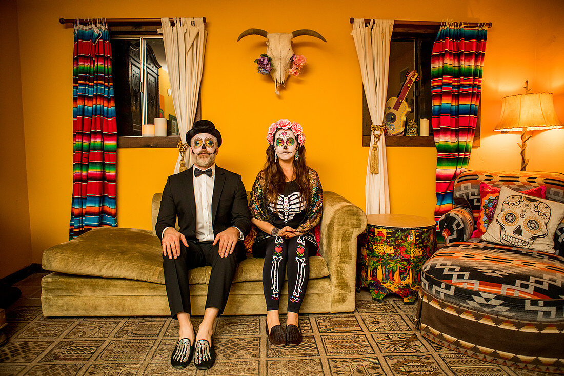 Man and woman in Dia de los Muertos makeup and costume, Day of the Dead celebration in the desert, California, United States of America, North America
