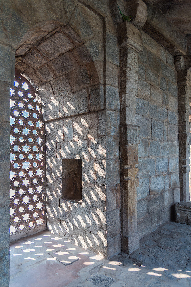 The intricate window carvings provide beautiful shadows at Qutub Minar, UNESCO World Heritage Site, New Delhi, India, Asia