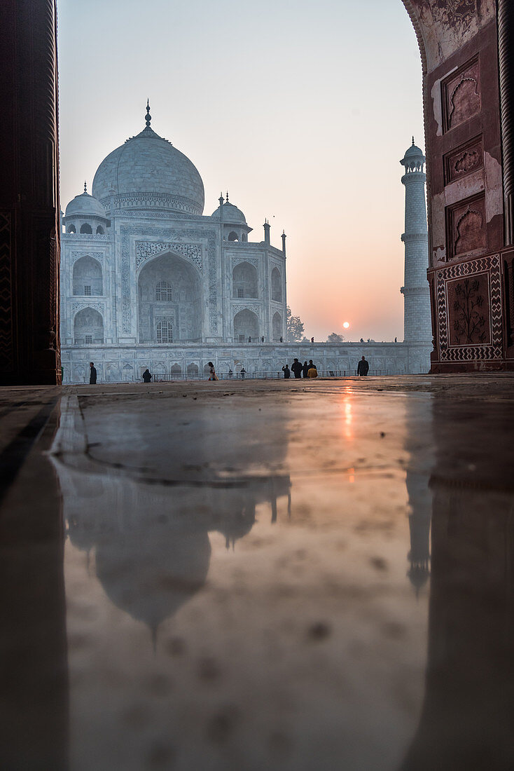 Reflections as the sun rises behind the Taj Mahal, UNESCO World Heritage Site, Agra, Uttar Pradesh, India, Asia