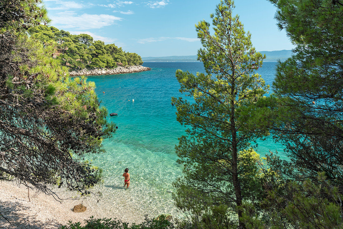 Woman bathing in the sea at Draceva beach, Murvica, Bol, Brac island, Split-Dalmatia county, Croatia, Europe