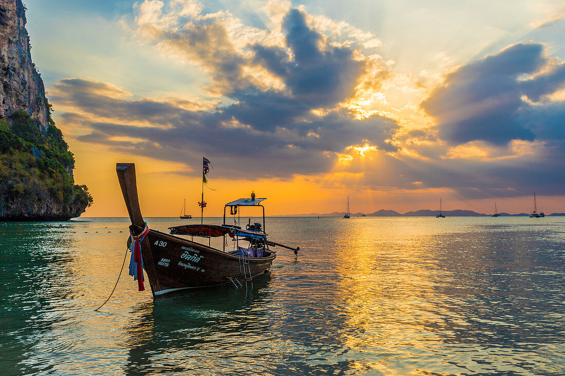 A long tail boat at sunset on Railay beach in Railay, Ao Nang, Krabi Province, Thailand, Southeast Asia, Asia