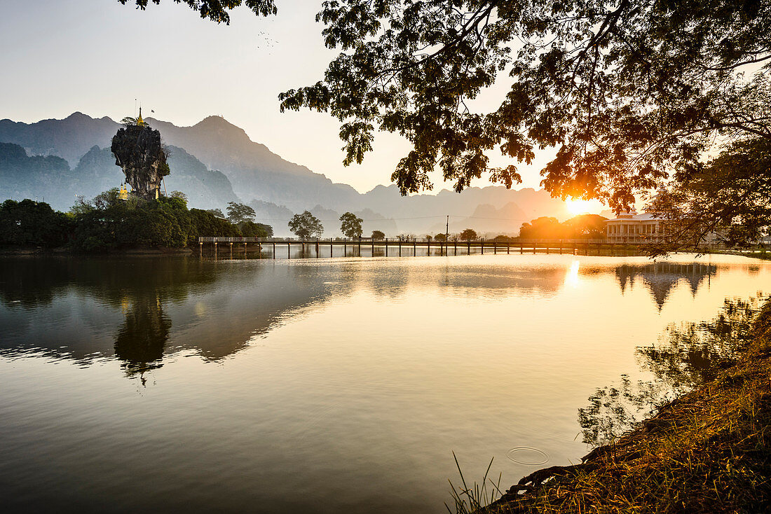 Mountains and bridge reflected in still lake, Hpa an, Kayin, Myanmar