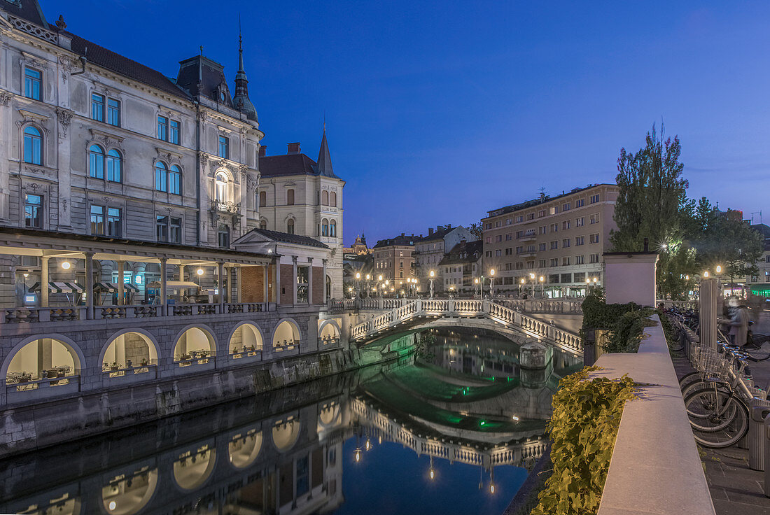 Buildings and pedestrian bridge over urban canal, Ljubljana, Central Slovenia, Slovenia