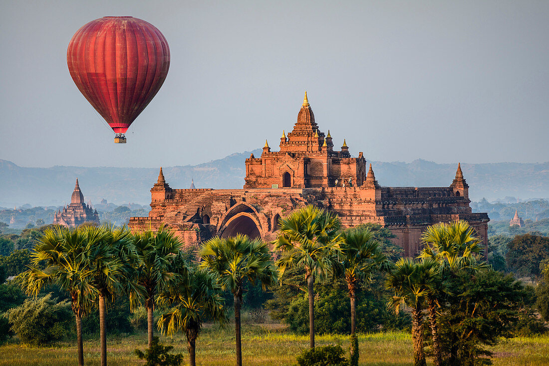 Hot air balloon flying over temple, Bagan, Myanmar