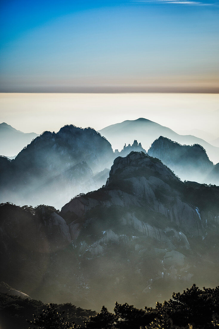 Fog rolling over rocky mountains, Huangshan, Anhui, China,