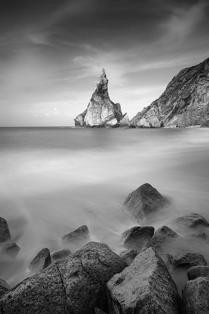 View of the rocks of Praia da Ursa, in the foreground small rocks, Colares, Sintra, Portugal