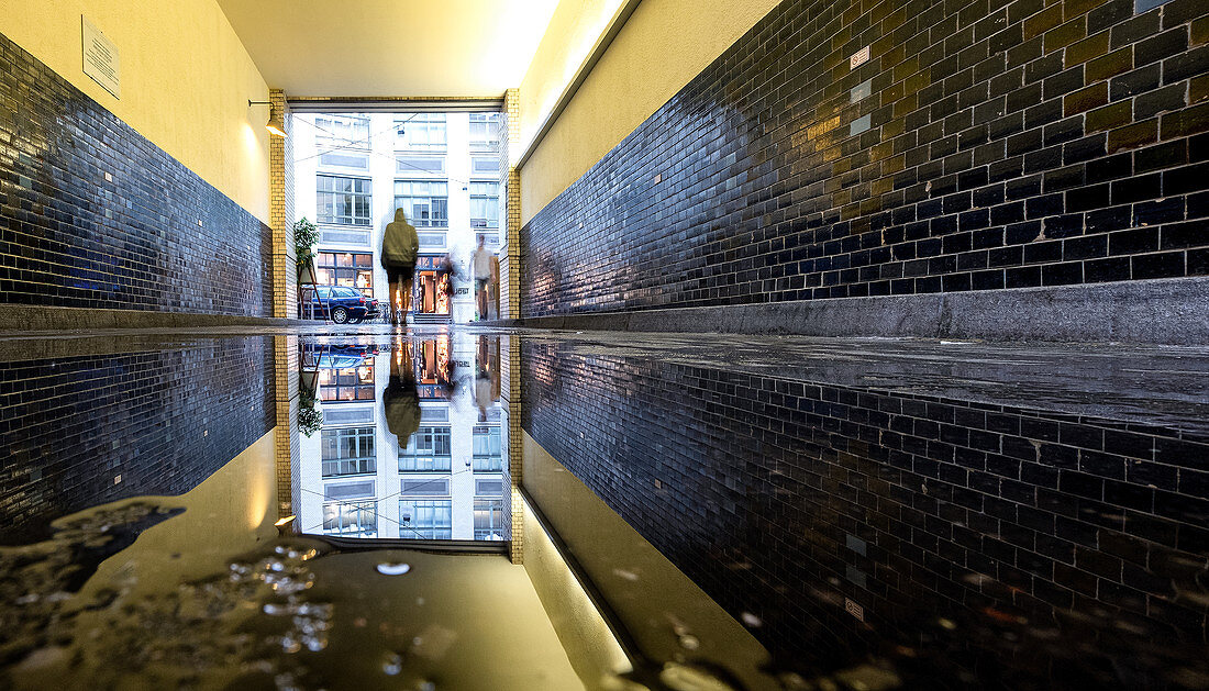 Reflection of the access passage into a courtyard in the Hackeschen Höfe, Mitte, Berlin, Germany