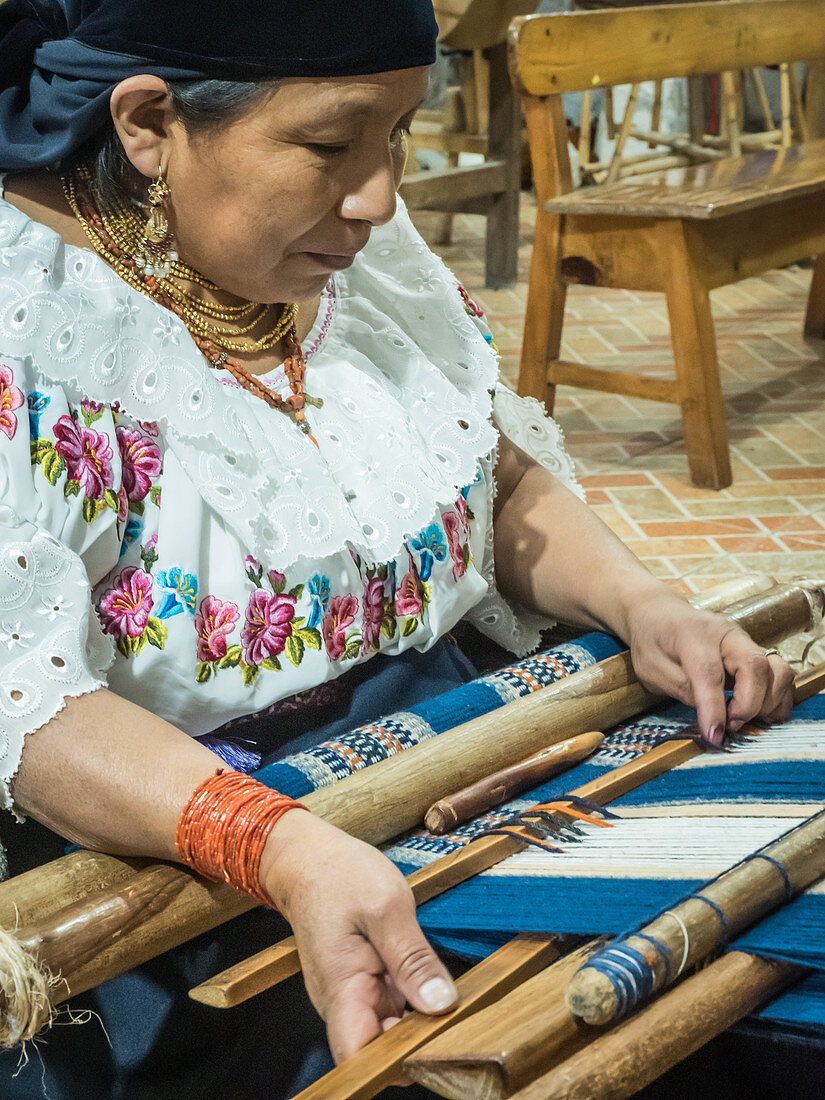 Indigenous woman weaving with backstrap loom, Otavalo, Ecuador, South America